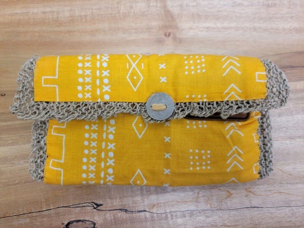 A yellow and gray wallet sitting on top of a table.