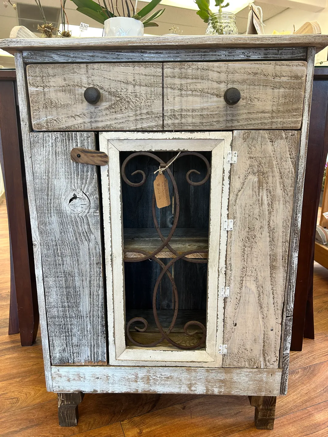 A cabinet with two drawers and one door.