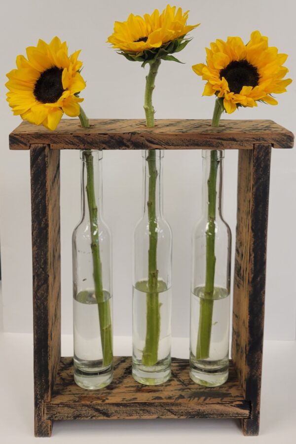 Three vases with flowers in them on a wooden stand.