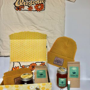 A 100% Oregonic Gift Box with a t - shirt, bees, and other items.