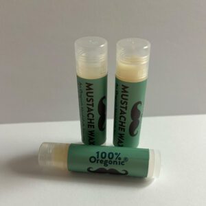 Three tubes of Mustache Wax on a white surface.